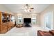 Cozy living room with carpet, ceiling fan, a large TV and a decorative window with custom valances at 2105 Sw 4Th St, Ocala, FL 34471