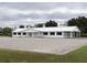 White horse barn with cupola and black window accents at 2190 Nw 110Th Ave, Ocala, FL 34482
