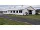 White horse barn with cupola and paved driveway at 2190 Nw 110Th Ave, Ocala, FL 34482