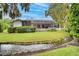 Charming home with a screened patio, lush lawn, and a peaceful creek at 2263 Se Laurel Run Dr, Ocala, FL 34471