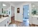 Modern bathroom with double vanity, walk-in shower, and hardwood floors at 2263 Se Laurel Run Dr, Ocala, FL 34471