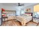 Bedroom with full-size bed, bunk beds, and wood floors at 2263 Se Laurel Run Dr, Ocala, FL 34471