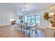 Elegant dining room with a farmhouse table and large windows at 2263 Se Laurel Run Dr, Ocala, FL 34471