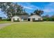 Single story home with stone accents and a manicured lawn at 2263 Se Laurel Run Dr, Ocala, FL 34471