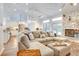 Bright and airy living room with large sectional sofa and open kitchen view at 2263 Se Laurel Run Dr, Ocala, FL 34471