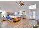 Spacious main bedroom with a king-size bed and French doors at 2263 Se Laurel Run Dr, Ocala, FL 34471