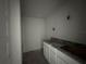Bathroom featuring a granite countertop, white cabinets and a large sink at 3 Willow Trl, Ocala, FL 34472