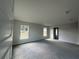 Bright, spacious bedroom with large windows offering natural light, neutral walls, and plush carpeting at 3 Willow Trl, Ocala, FL 34472
