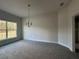 Inviting dining area with ample natural light, featuring neutral walls, new carpeting, and a modern chandelier at 3 Willow Trl, Ocala, FL 34472