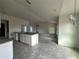 Open-concept kitchen featuring an island with granite countertops and view into a large living space at 3 Willow Trl, Ocala, FL 34472