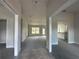 Bright, open-concept living room with a large window and neutral-colored walls, complemented by new gray carpeting at 3 Willow Trl, Ocala, FL 34472