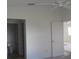 Simple bedroom with ceiling fan and bathroom access at 321 Katherine Pl, The Villages, FL 32162