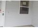White vinyl siding and a window with a screen at 321 Katherine Pl, The Villages, FL 32162