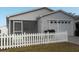 Cute house with white picket fence and a two-car garage at 321 Katherine Pl, The Villages, FL 32162
