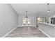 Spacious dining area with LVP flooring and double French doors leading outside at 4065 Sw 5Th Ave, Ocala, FL 34471