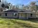 House with gray siding, covered patio, and spacious backyard at 4065 Sw 5Th Ave, Ocala, FL 34471