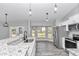 Modern kitchen with granite countertops, stainless steel appliances, and white cabinets at 4065 Sw 5Th Ave, Ocala, FL 34471