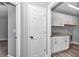 Laundry room with white cabinets, granite countertop, and vinyl flooring at 4065 Sw 5Th Ave, Ocala, FL 34471