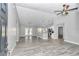 Open living room with gray walls, vinyl flooring, and kitchen view at 4065 Sw 5Th Ave, Ocala, FL 34471