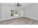 Bright living room featuring neutral walls, LVP flooring, and a large window at 4065 Sw 5Th Ave, Ocala, FL 34471