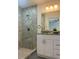 Bathroom featuring a walk-in shower with grey tile, single vanity and a grey granite countertop at 4698 Sw Zinnia, Dunnellon, FL 34431