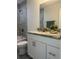 Bathroom featuring a tub and shower with grey tile surround, single vanity and laminate flooring at 4698 Sw Zinnia, Dunnellon, FL 34431