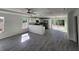 Open floor plan with a modern kitchen and grey vinyl flooring at 4698 Sw Zinnia, Dunnellon, FL 34431