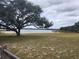 Peaceful lakefront view with dock and lush trees at 4698 Sw Zinnia, Dunnellon, FL 34431