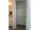 Open view into the storage closet with wire shelving and grey laminate flooring at 4698 Sw Zinnia, Dunnellon, FL 34431