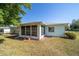 Charming home with a spacious, screened-in porch that provides a comfortable outdoor space for relaxation and entertainment at 6184 Sw 101St Pl, Ocala, FL 34476