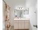Bathroom featuring a vanity with storage, a sink, a mirror, lighting fixtures, and a shower with curtain at 6184 Sw 101St Pl, Ocala, FL 34476