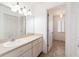 Clean bathroom with a long vanity, sink, mirror, and a view of the shower at 6184 Sw 101St Pl, Ocala, FL 34476