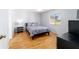 Comfortable bedroom with laminate wood flooring and a window offering natural light at 6184 Sw 101St Pl, Ocala, FL 34476