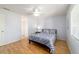 Bright bedroom with a ceiling fan, laminate wood flooring, and natural light at 6184 Sw 101St Pl, Ocala, FL 34476