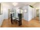 Elegant dining room featuring a glass table, modern chairs, and sliding glass doors to the lanai at 6184 Sw 101St Pl, Ocala, FL 34476