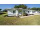 Inviting single-story home featuring a neatly kept lawn and attractive landscaping at 6184 Sw 101St Pl, Ocala, FL 34476