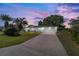 Exterior of the home at dusk, featuring lush landscaping and a spacious two-car garage at 6184 Sw 101St Pl, Ocala, FL 34476