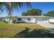 Charming single-story home with a well-maintained lawn, two-car garage, and lush landscaping at 6184 Sw 101St Pl, Ocala, FL 34476