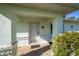 Close-up of the home's entrance, showcasing the covered porch and the front door with sidelight at 6184 Sw 101St Pl, Ocala, FL 34476