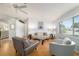 Bright living room featuring wood floors, comfortable seating, and ample natural light at 6184 Sw 101St Pl, Ocala, FL 34476