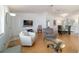 Open-concept living room with modern decor and ample natural light, seamlessly connected to the dining area at 6184 Sw 101St Pl, Ocala, FL 34476