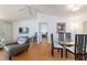 Open-concept living and dining area with stylish furnishings, hardwood floors, and a modern ceiling fan at 6184 Sw 101St Pl, Ocala, FL 34476