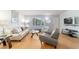 Inviting living room with wood floors, comfortable furnishings, and ample natural light at 6184 Sw 101St Pl, Ocala, FL 34476