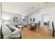 Bright living room featuring modern furnishings, natural light, and a ceiling fan for added comfort at 6184 Sw 101St Pl, Ocala, FL 34476