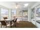 Inviting sunroom provides ample natural light from surrounding windows and a ceiling fan for comfortable air circulation at 6184 Sw 101St Pl, Ocala, FL 34476