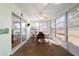 Light filled sunroom with carpet flooring, many windows, ceiling fan, and sliding door to home's interior at 6184 Sw 101St Pl, Ocala, FL 34476