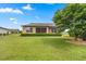 House exterior view showcasing a large backyard with lush lawn at 6689 Sw 95Th Cir, Ocala, FL 34481