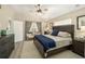 Main bedroom with a king-size bed, large windows and plenty of closet space at 6871 Sw 111Th Loop, Ocala, FL 34476