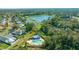 Aerial view of neighborhood with lake and pool at 772 Horseman Dr, Port Orange, FL 32127