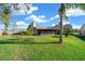 Landscaped backyard with lush grass and palm trees at 772 Horseman Dr, Port Orange, FL 32127